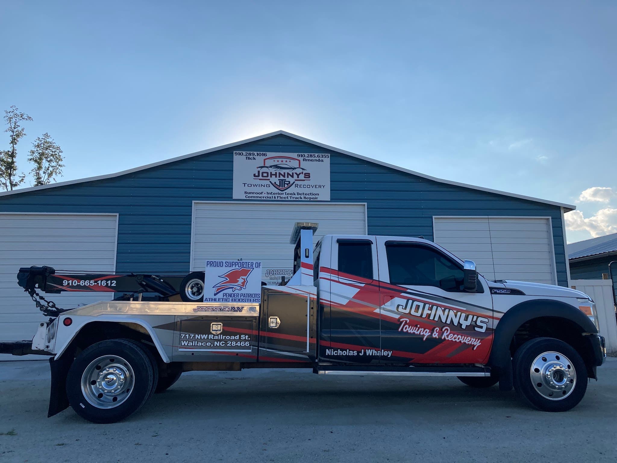 Johnny's Towing & Recovery branded tow truck outside the shop in Wallace, NC